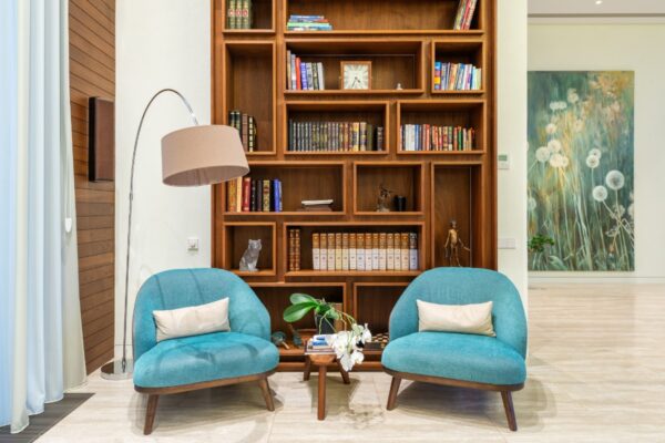 two blue chairs in a home library